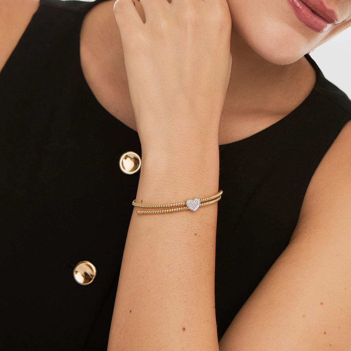 Pulsera 2 oros de 18K retractil entorchado c/ dije corazon