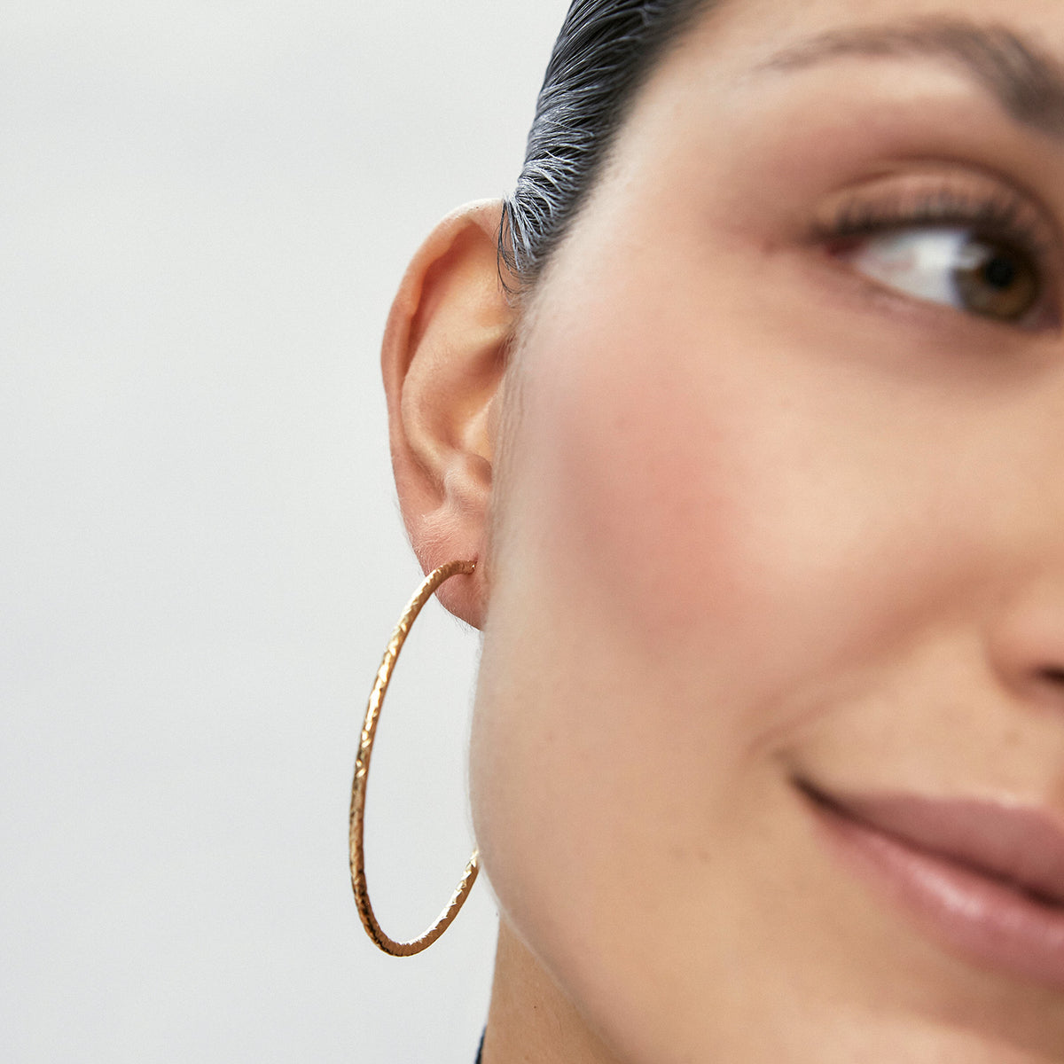 Aretes en oro amarillo de 18K, argollas tipo entorchada y diamantada