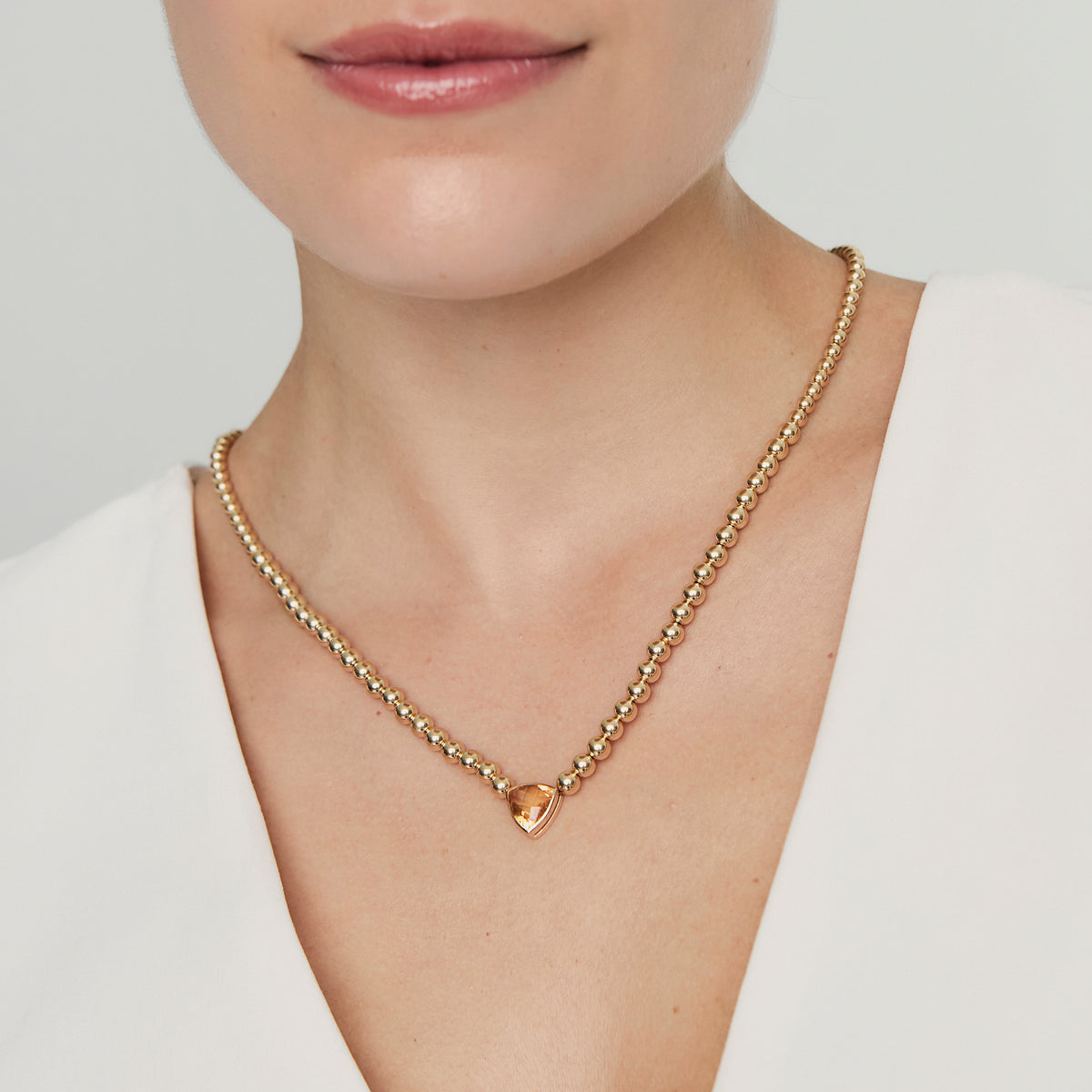 Collar en oro amarillo 18K con citrino trillant con bead y regulador