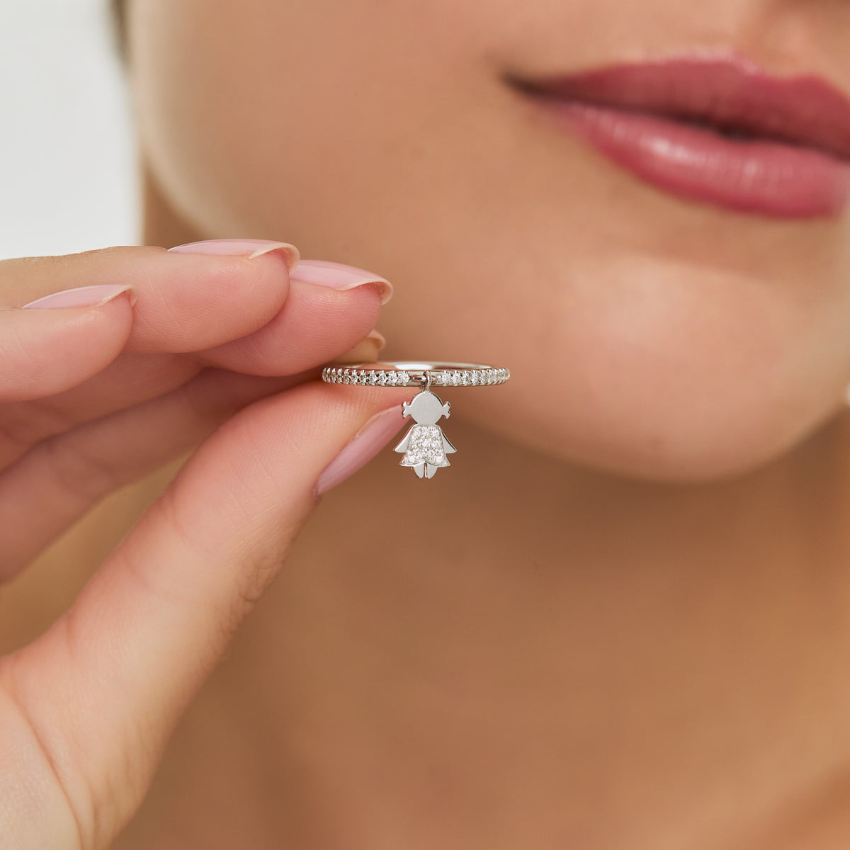 Anillo oro blanco 18K medio rivière con niña colgante