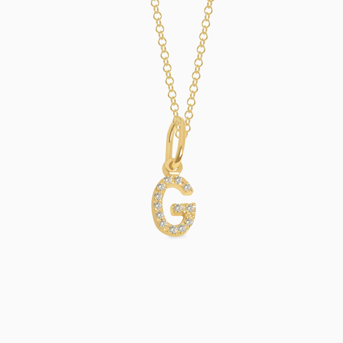 Dije en oro amarillo de 18K letra G full brillantes