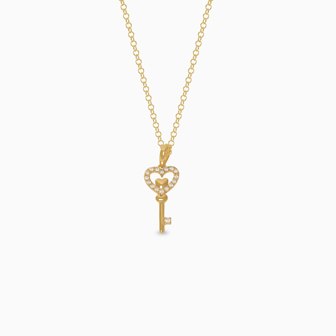 Dije en oro amarillo de 18K llave corazón con brillantes